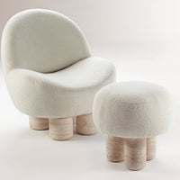 Soft cream-colored chair and ottoman with rounded shapes and textured fabric, featuring wooden legs for a modern look.
