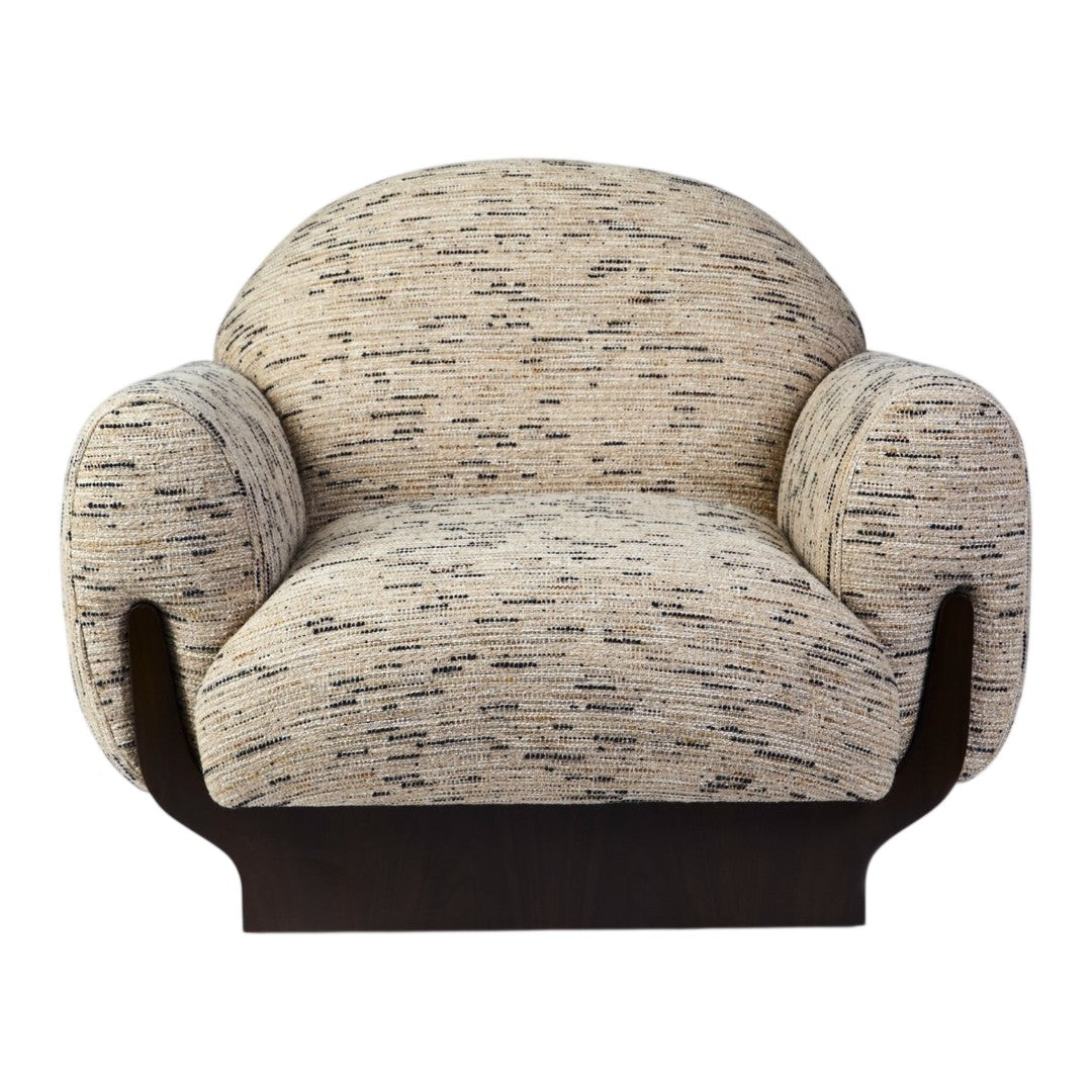 Textured cream and brown armchair featuring a unique speckled pattern with a sleek dark wooden base.