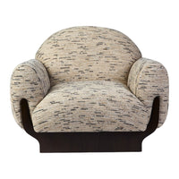 Textured cream and brown armchair featuring a unique speckled pattern with a sleek dark wooden base.