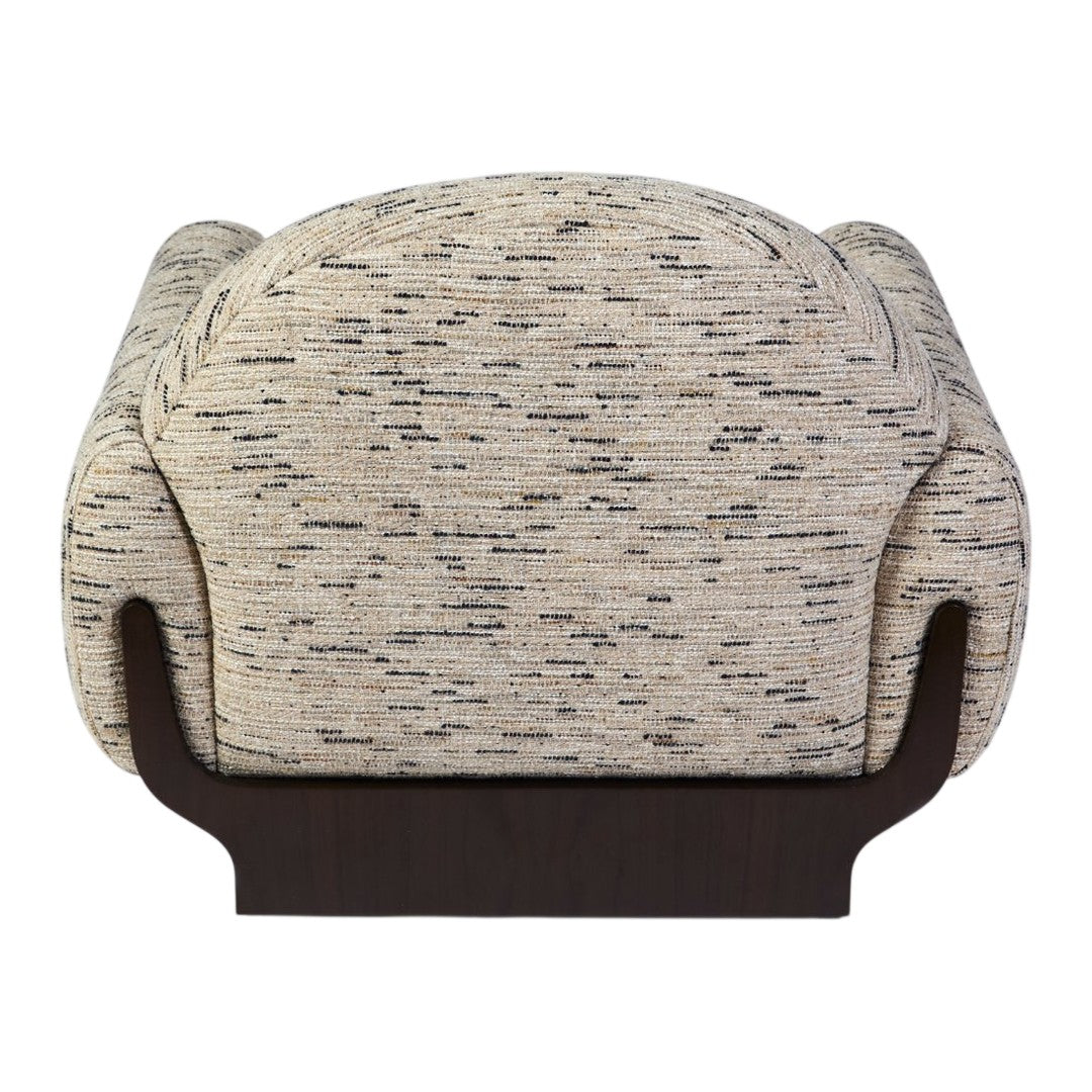 Textured beige fabric with subtle gray and black speckles, featuring a smooth dark wood base. Modern accent chair design.