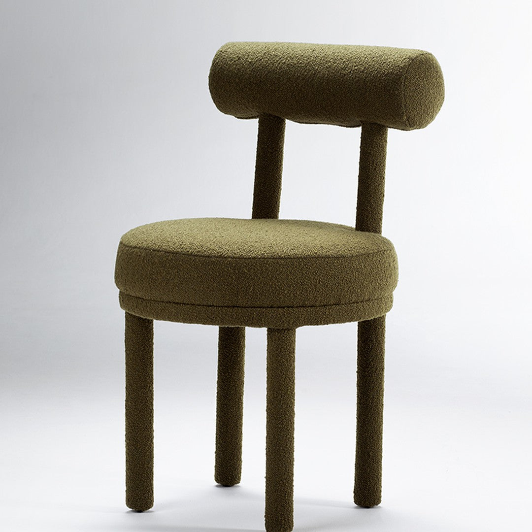 Olive green upholstered chair with a rounded backrest and textured fabric, featuring cylindrical legs.
