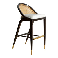 Brown rattan bar stool with white cushion and gold accents, featuring a sleek, modern design.
