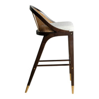 Dark wood bar stool with a natural woven back, white cushion, and gold-tipped legs, combining chic and modern design.