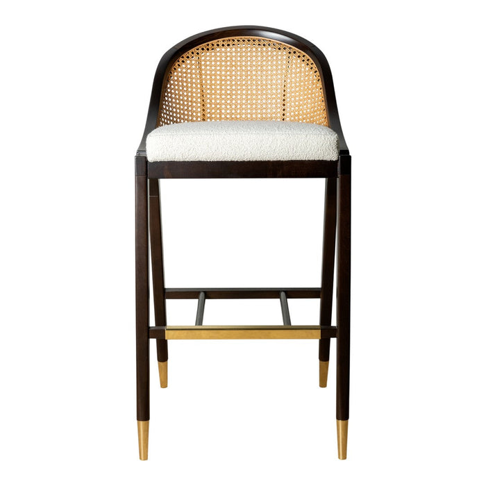 Dark brown bar stool with a natural cane back, beige cushion seat, and gold-tipped legs. Modern, elegant design.