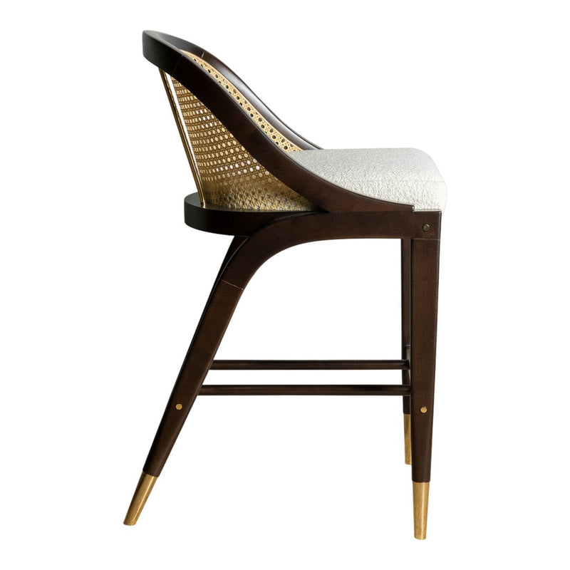 Elegant brown wooden bar stool with caned back, white cushion, and gold accents on tapered legs.