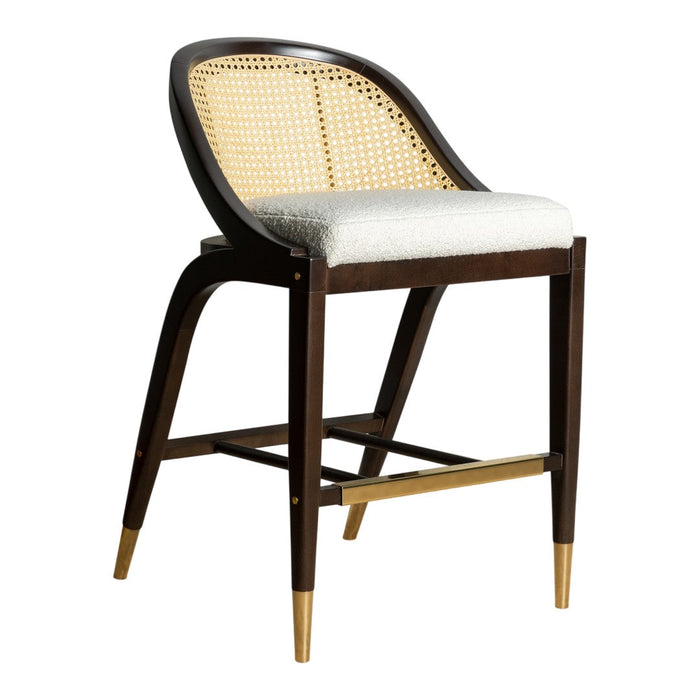 Brown wooden bar stool with natural cane seating and a white upholstered cushion, featuring brass-finished legs.
