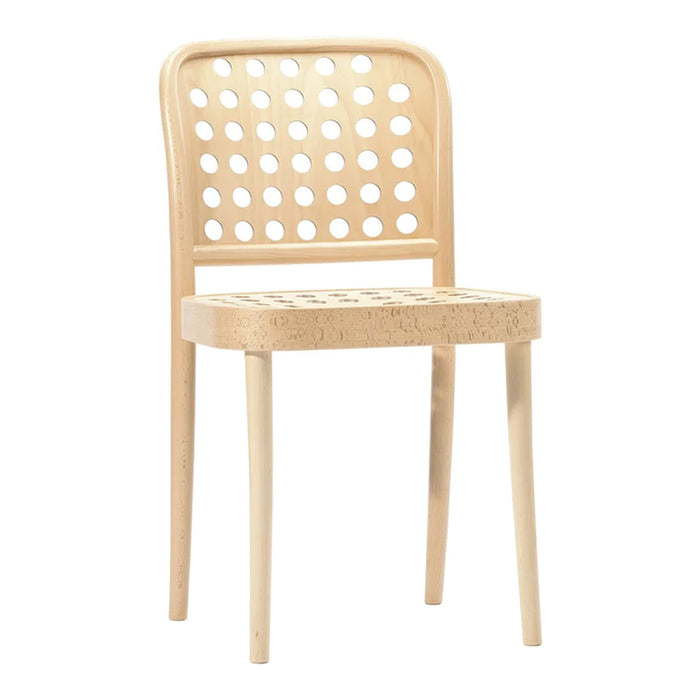 Light wood chair with a polka dot design and natural finish, perfect for modern decor.