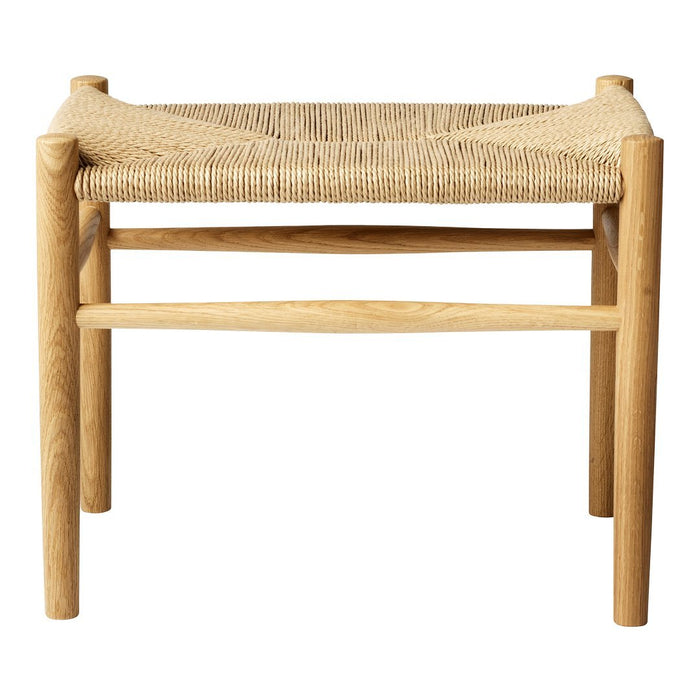 Natural wood stool with a woven beige seat, featuring a minimalist design and organic textures. Perfect for modern decor.