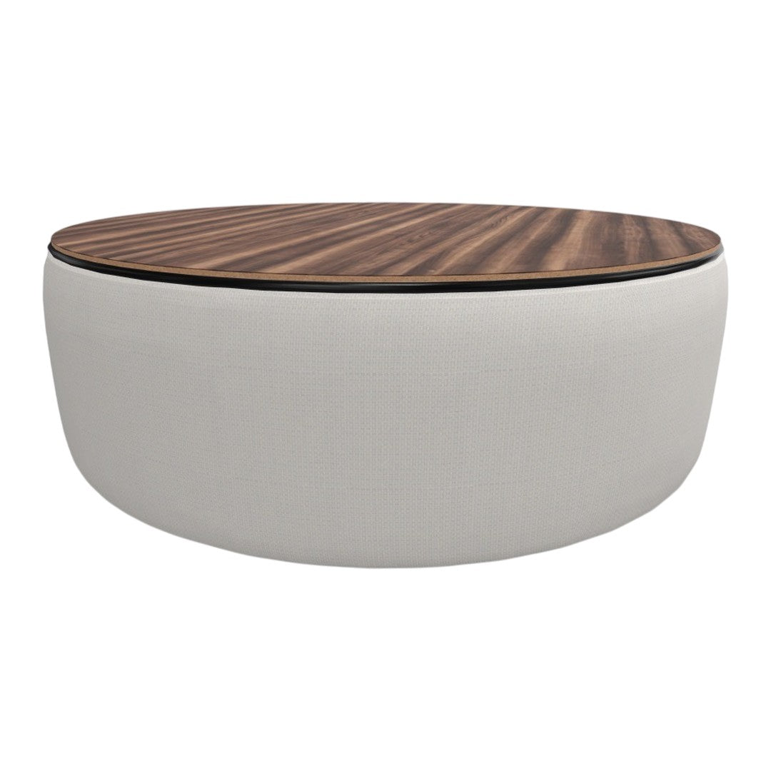 Round coffee table with a smooth white cushion base and a rich dark wood patterned top. Elegant and modern design.