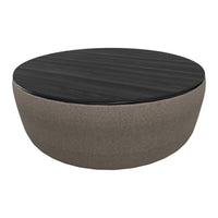 Round coffee table featuring a dark wood top and a soft, beige fabric base for a modern look.