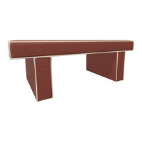 Red upholstered bench with subtle texture and cream piping accents. Stylish and contemporary design for modern spaces.