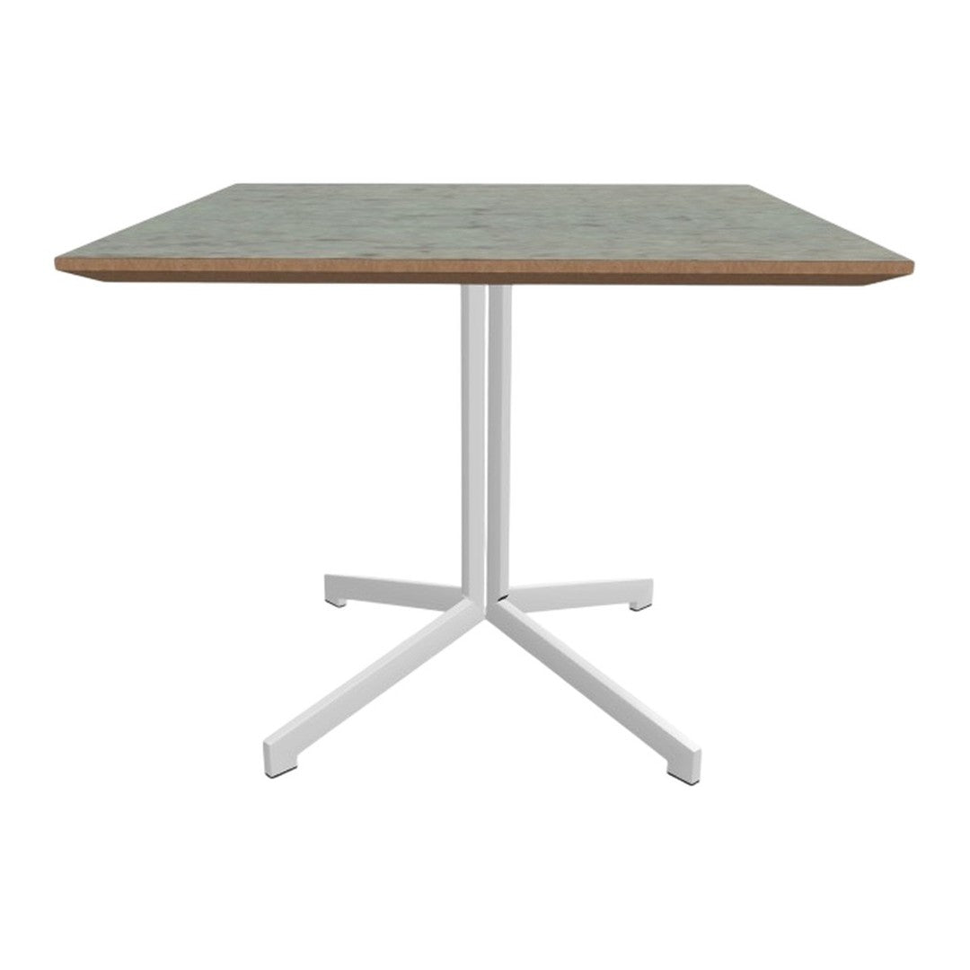 Square dining table with a light green patterned top and white metal legs, perfect for modern decor.