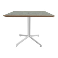 Square dining table with a light green patterned top and white metal legs, perfect for modern decor.