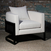 Light gray upholstered armchair with a solid black base, featuring a sleek, minimalist design and a textured fabric pattern.