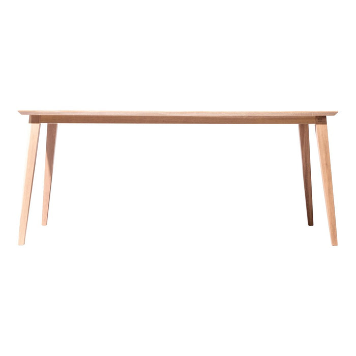 Light wooden table with a smooth surface and slim, tapered legs in natural oak finish, showcasing minimalist design.