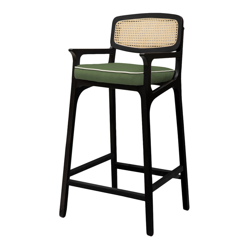 Black wooden bar stool with a green cushion and woven cane backrest, adding a touch of modern elegance.