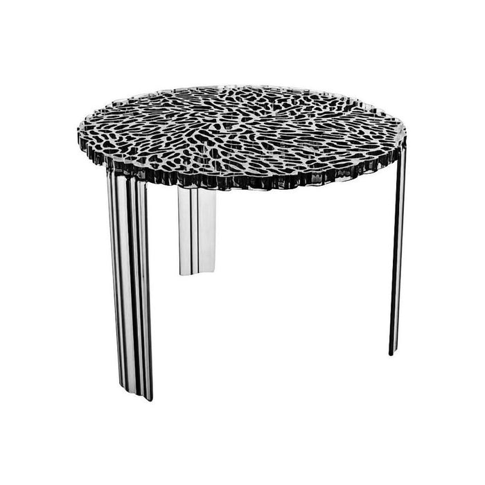 Round table featuring a textured black and white pattern with sleek metallic legs, adding modern elegance to any space.