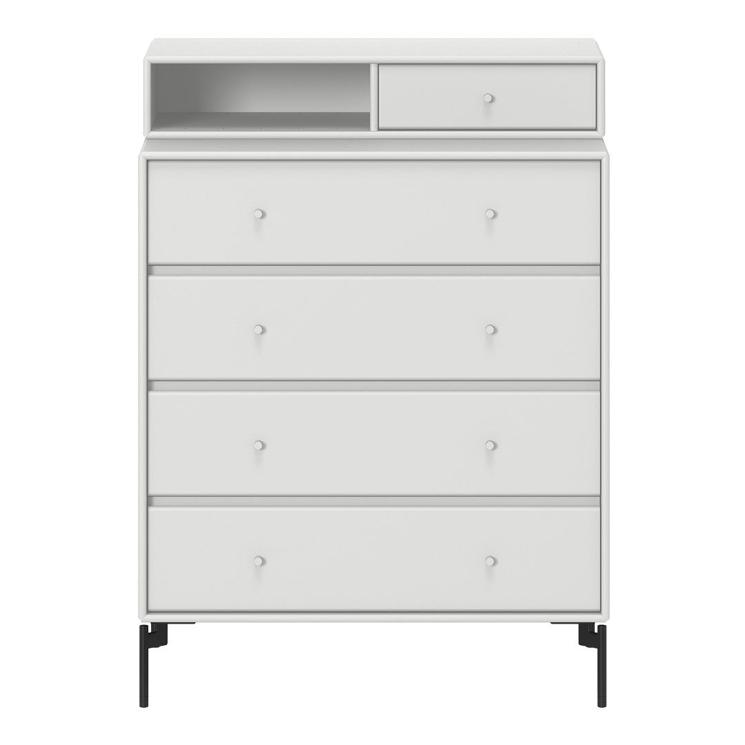 White modern dresser with clean lines and minimalistic design; features sleek black legs and simple knob handles.
