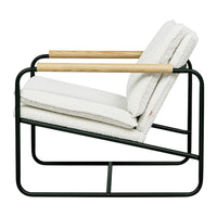 Cream upholstered chair with cozy texture, black metal frame, and natural wood armrest accents. Modern minimalist design.