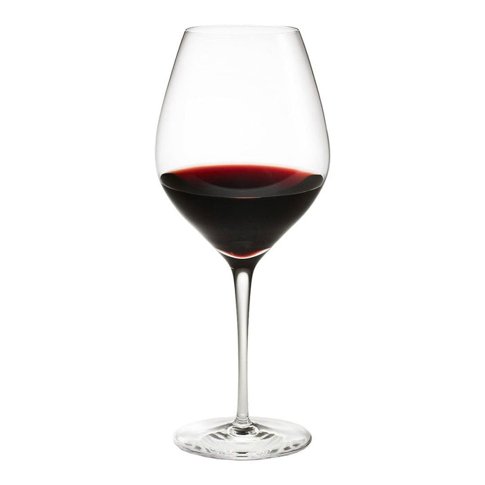 Elegant clear wine glass filled with rich, deep red wine, showcasing smooth curves and a classic design.