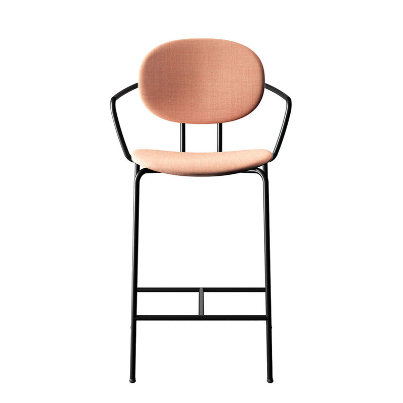 Peach fabric seat with a smooth texture, set on a sleek black metal frame. Modern and stylish design.