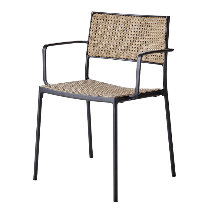 Black metal chair with a woven rattan seat and backrest, showcasing a natural tan color and geometric pattern.