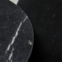 Black marble surfaces featuring elegant white veining and smooth textures, highlighting a modern aesthetic.