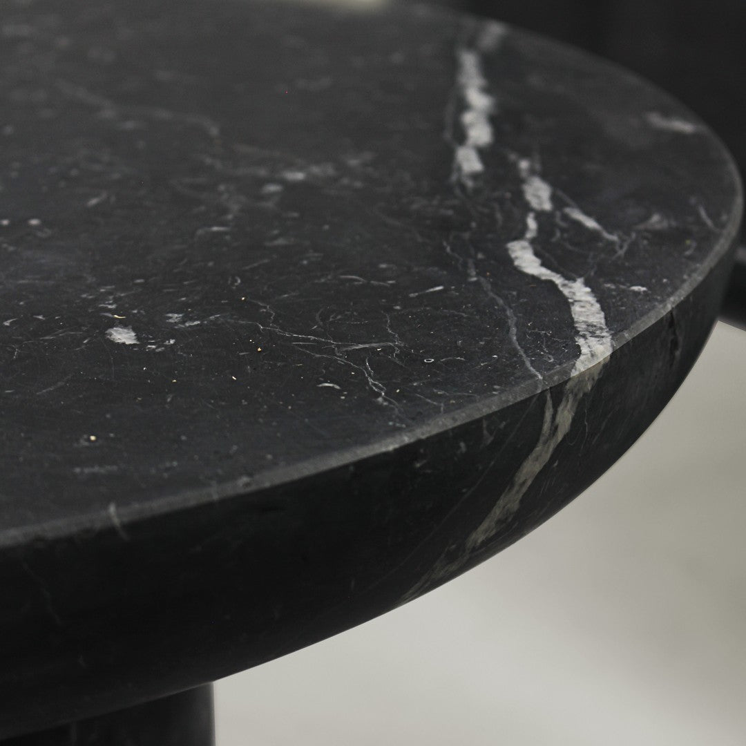 Black marble tabletop featuring sleek, polished surface with white veining and subtle texture. Elegant and modern design.
