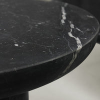 Black marble tabletop featuring sleek, polished surface with white veining and subtle texture. Elegant and modern design.