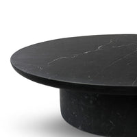 Black marble round table with subtle white veining, showcasing a sleek, modern design and elegant finish.
