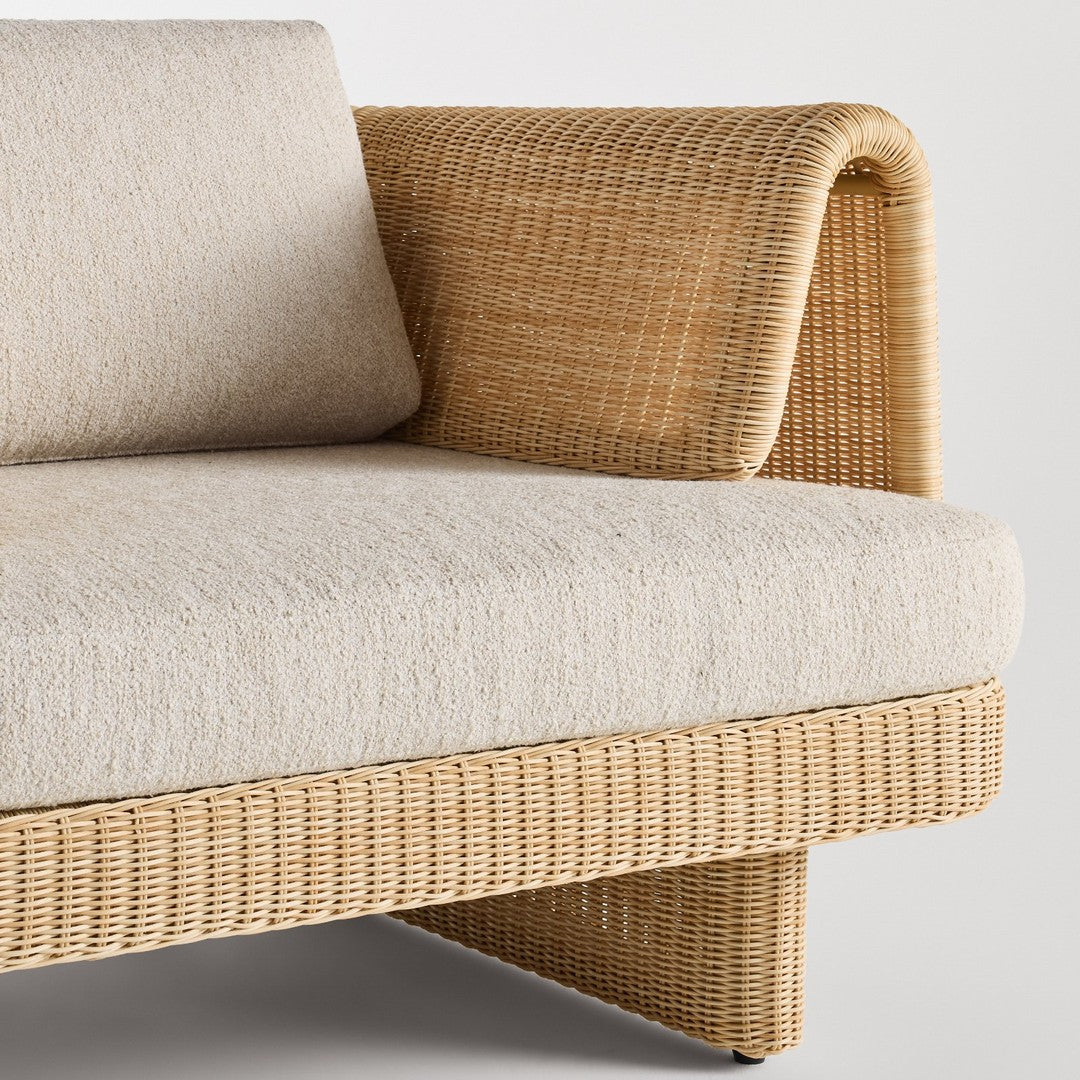 Beige linen upholstery with a natural woven rattan base, featuring a contemporary curved design.