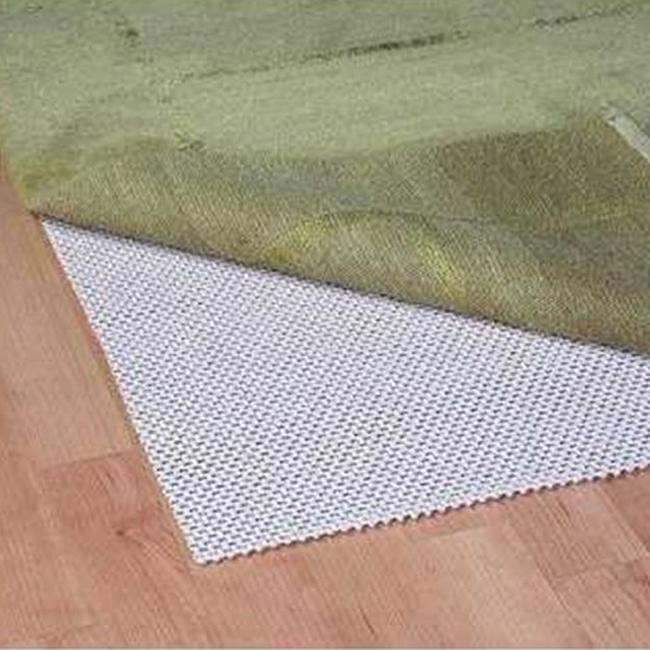 Green textured rug edge over white non-slip mat on a wooden floor.