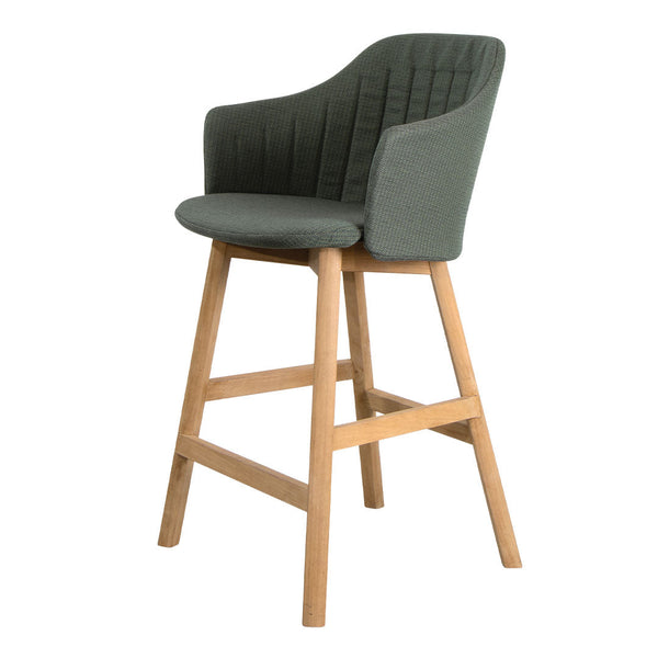 Green upholstered bar chair with vertical quilted pattern and natural wood legs. Modern and stylish design.