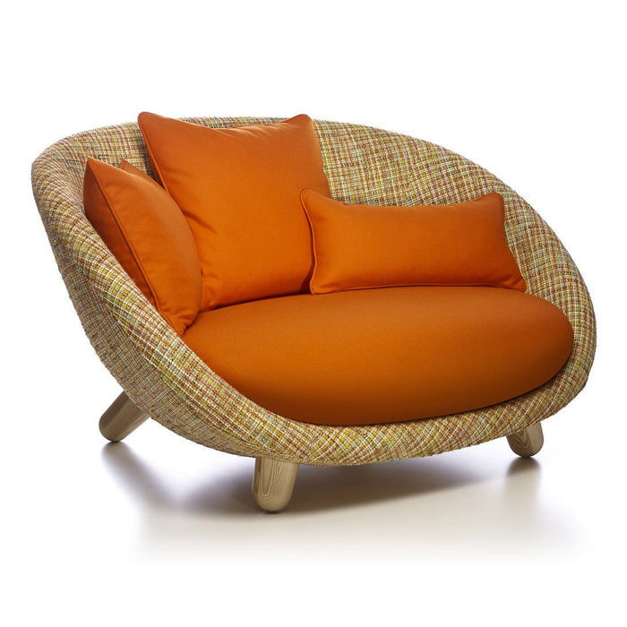 Textured woven sofa in neutral tones with bright orange accent cushions, featuring a modern, circular design.