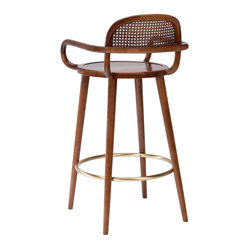 Wooden bar stool with a natural finish, woven cane seat, and gold accent footrest for a modern touch.