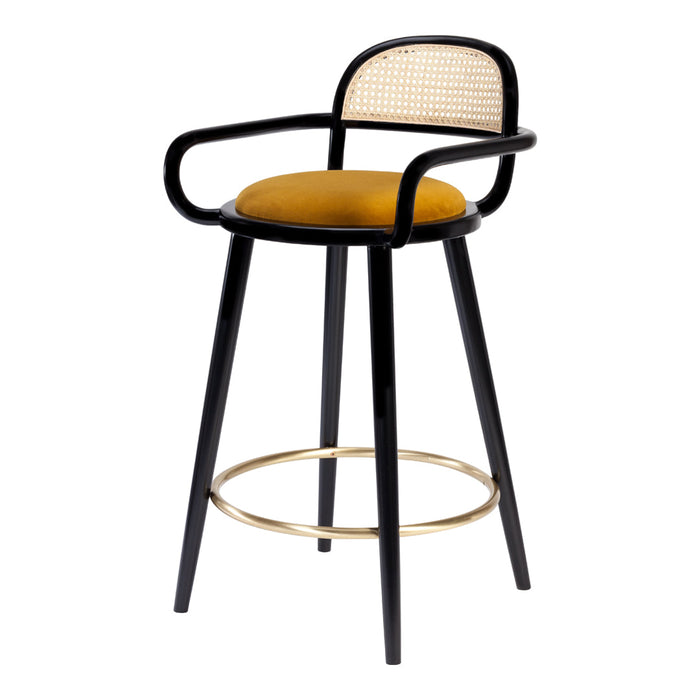Black and mustard bar stool with cane backrest and gold footrest, showcasing a modern, chic design.