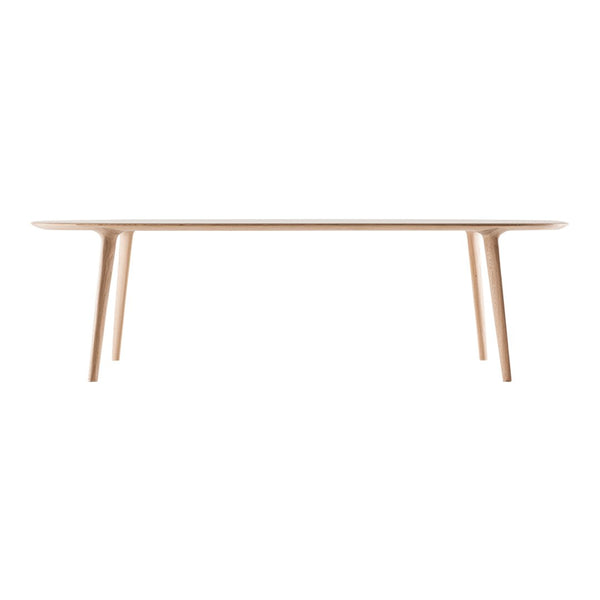Light wood dining table with a smooth surface and minimalist design, showcasing natural beige tones and clean lines.