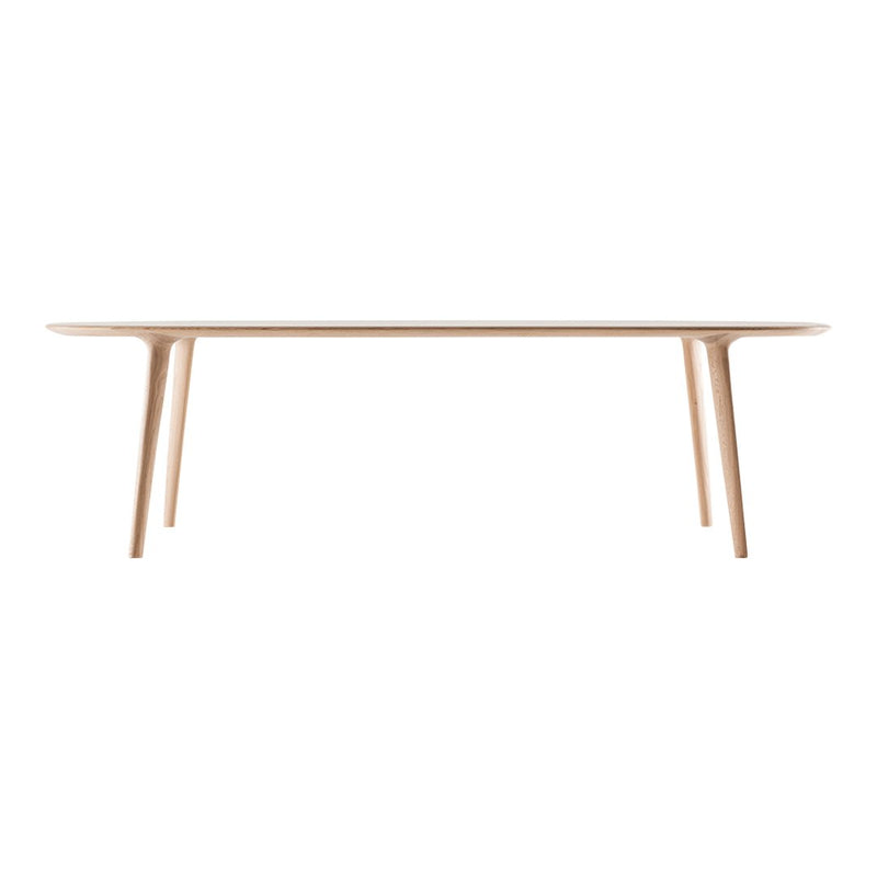 Light wood dining table with a smooth surface and minimalist design, showcasing natural beige tones and clean lines.