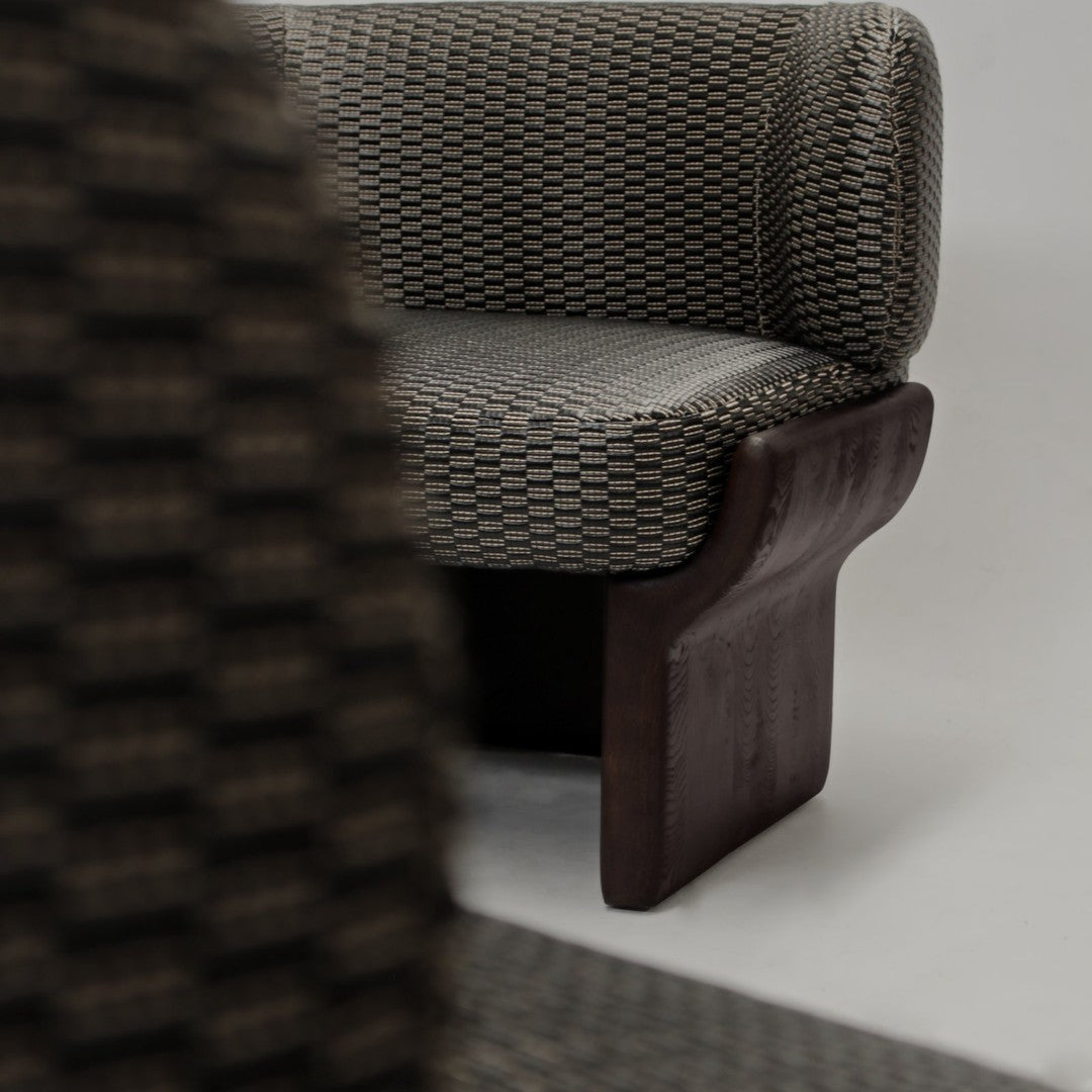 Textured gray and brown patterned chair with a sleek, curved wooden base. Modern design for stylish interiors.