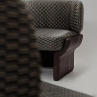 Textured gray and brown patterned chair with a sleek, curved wooden base. Modern design for stylish interiors.