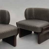 Gray patterned upholstery on modern chairs with dark wooden bases, featuring a geometric design.