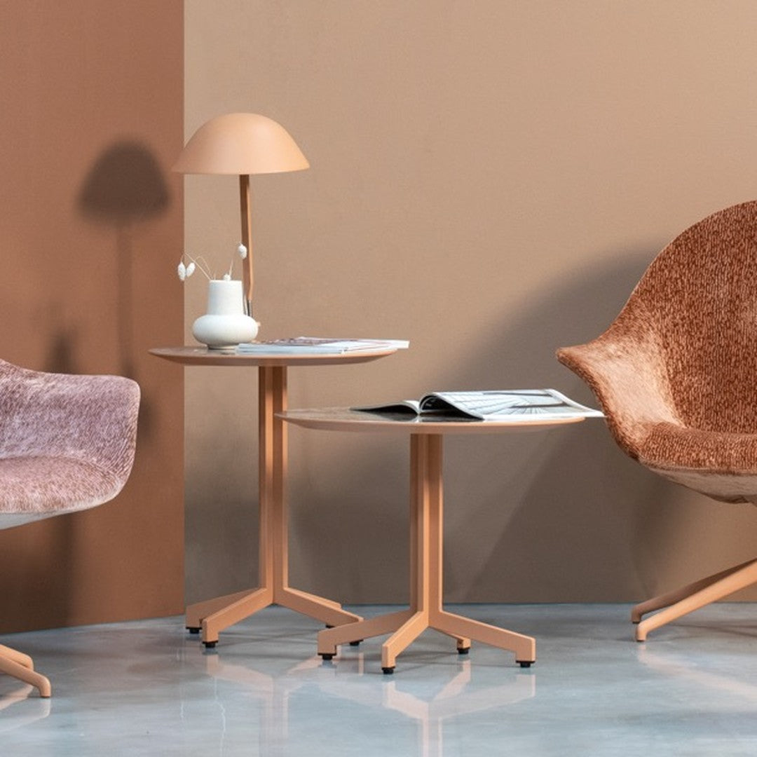 "Soft peach and terracotta tones create a warm, modern aesthetic with textured patterns in furniture and decor."