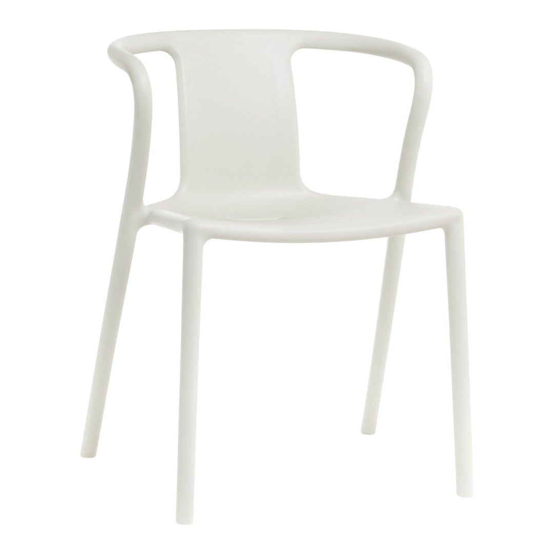 White plastic chair with a minimalist design and smooth, curved lines. Perfect for modern home decor.