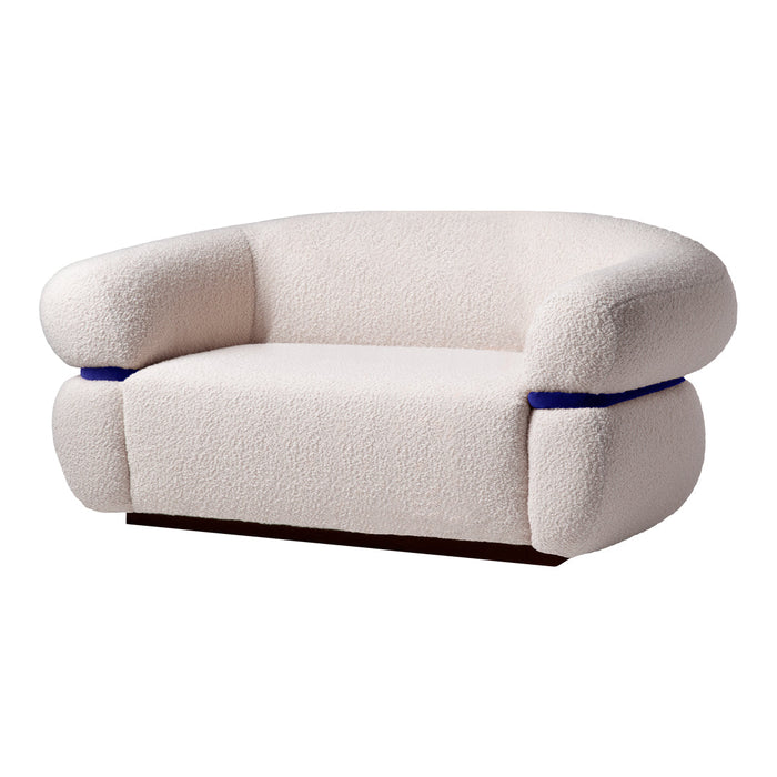 Cream-colored sofa with a soft, textured fabric and blue accent detailing on the sides. Modern, cozy design.