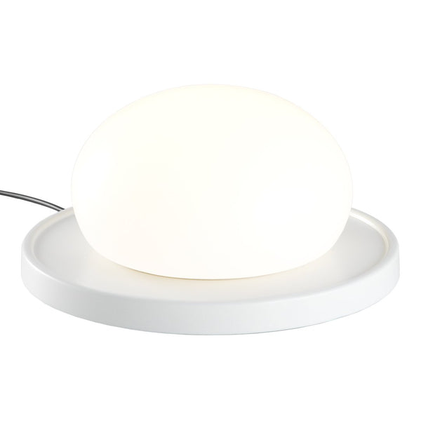 White oval lamp on a round white base, emitting a soft glow for a modern, minimalist look.
