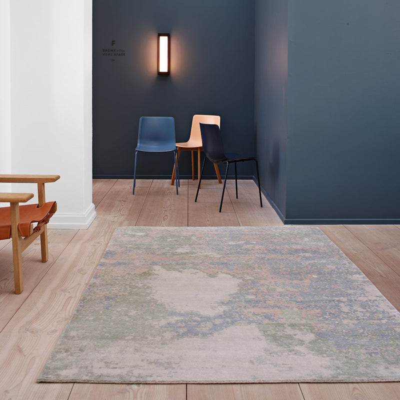 Soft pastel rug with a blend of blue, green, and muted earth tones in an abstract pattern, perfect for modern decor.
