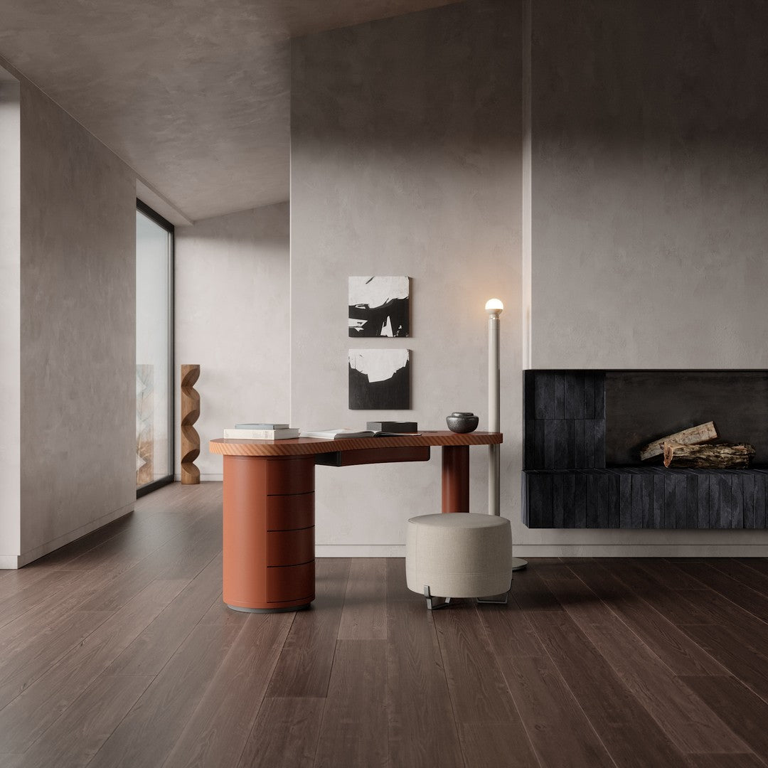 Stylish modern desk in terracotta with creamy stool, set against neutral gray walls and dark wooden flooring.