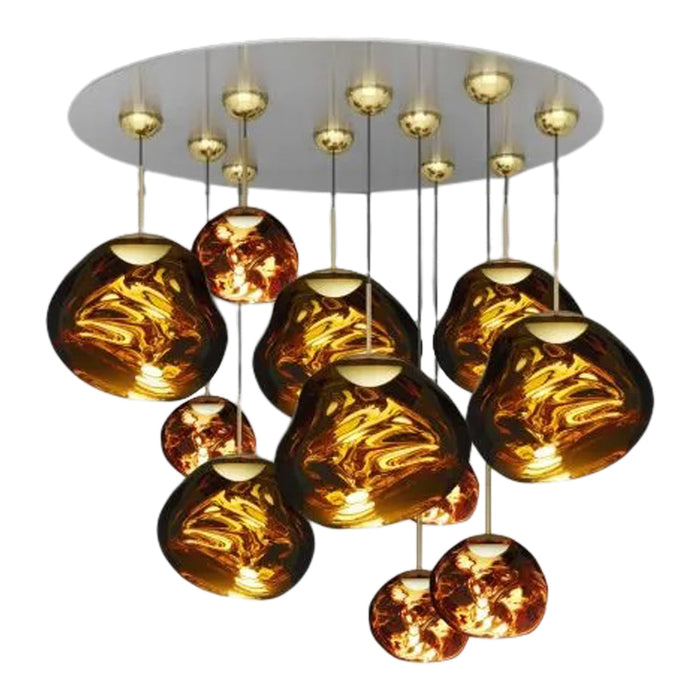 "Modern chandelier with golden organic shapes, reflecting warm amber tones against a sleek silver canopy."