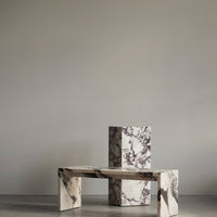 "Textured black and white marble table set with unique patterns and finishes."