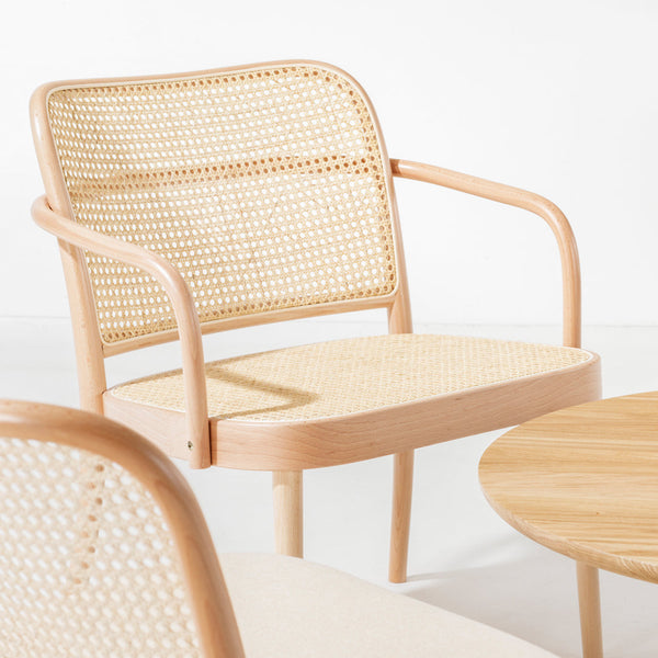 Light wood armchair with woven rattan seat and back, featuring a natural finish and minimalistic design.